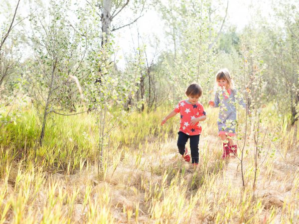 kids walking through a field