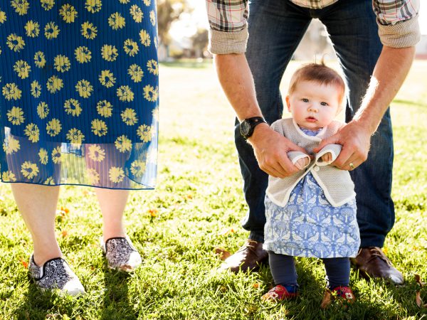 baby and parents in the grass