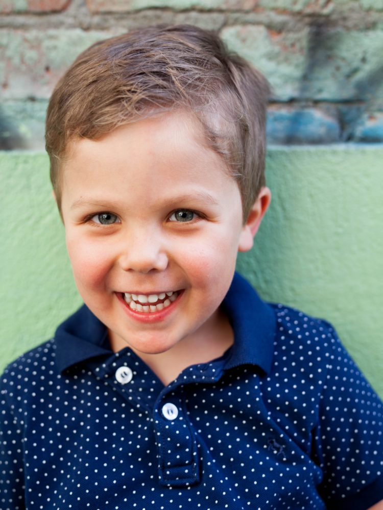 smiling boy in blue shirt