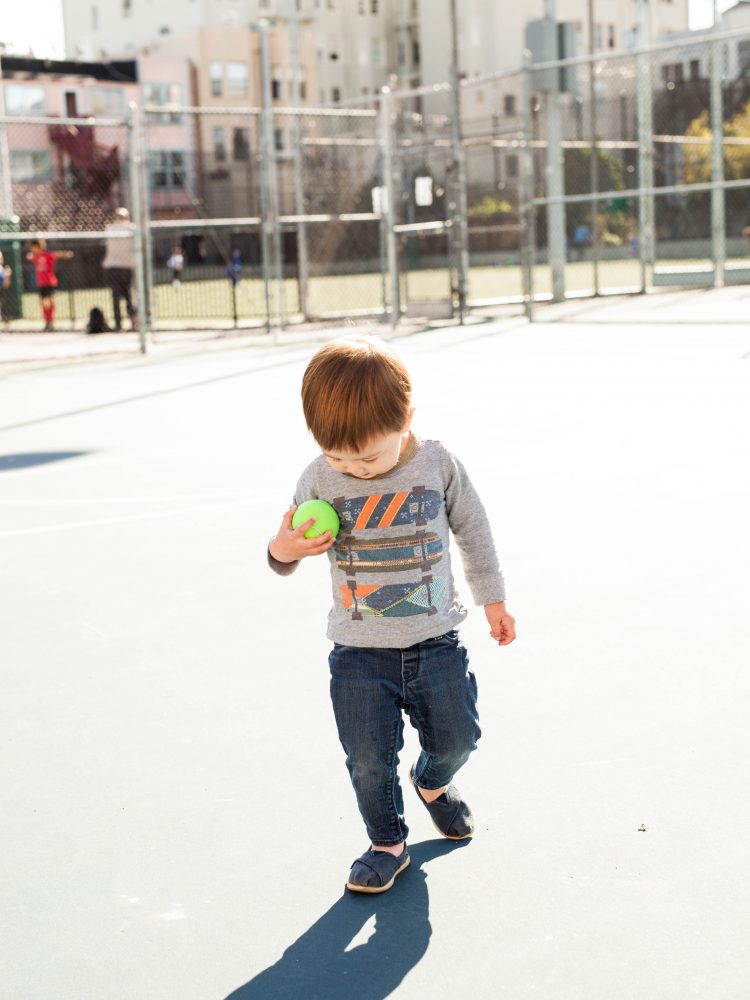 boy holding tennis ball