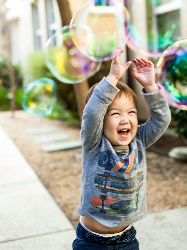 boy playing with bubbles