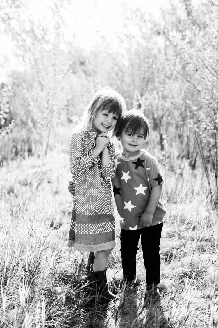 kids standing ourdoors in black and white