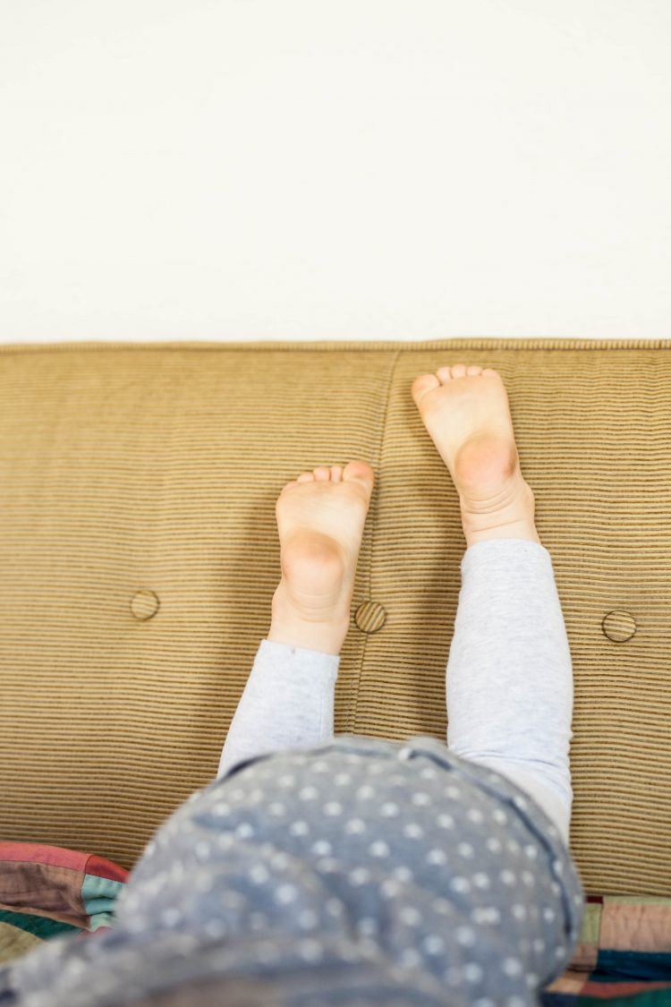 kid's feet on sofa