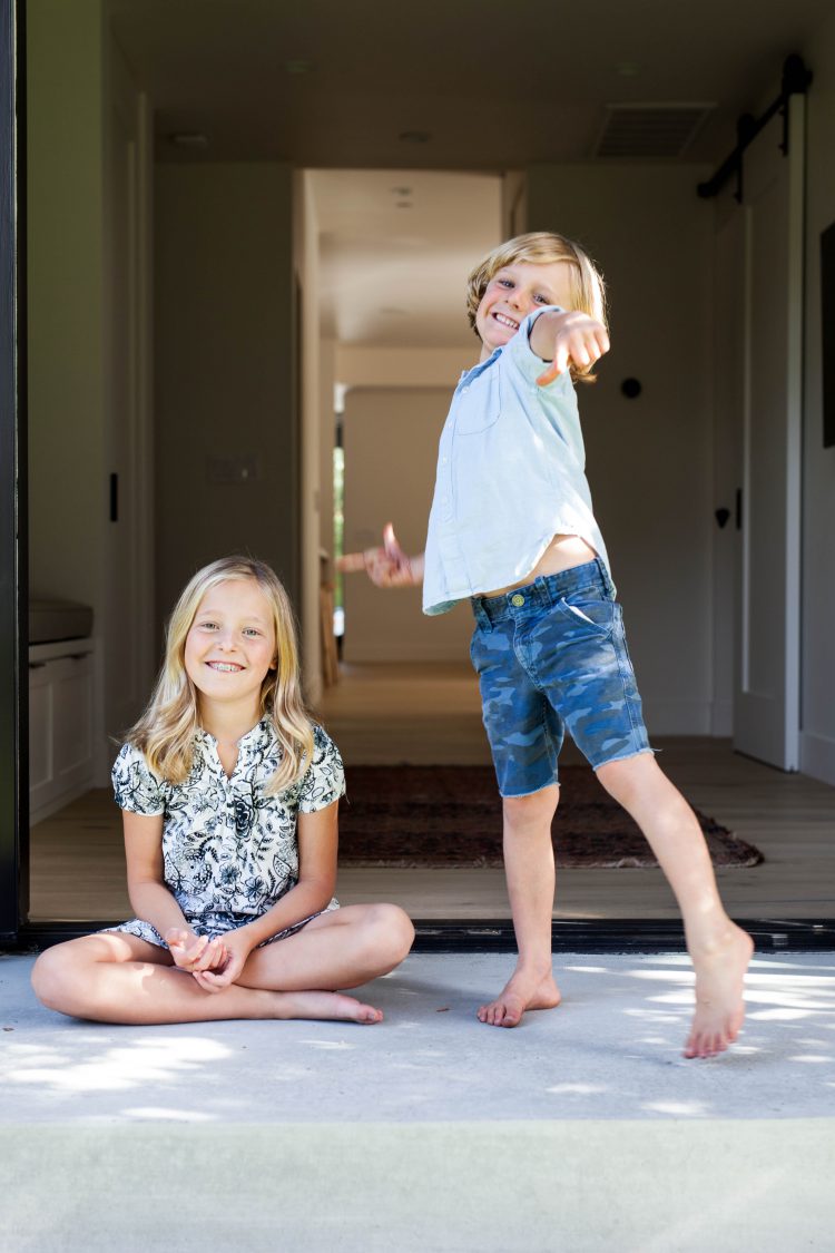 happy kids outside modern house