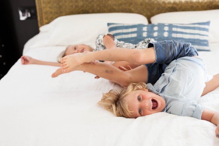 kids playing on a bed