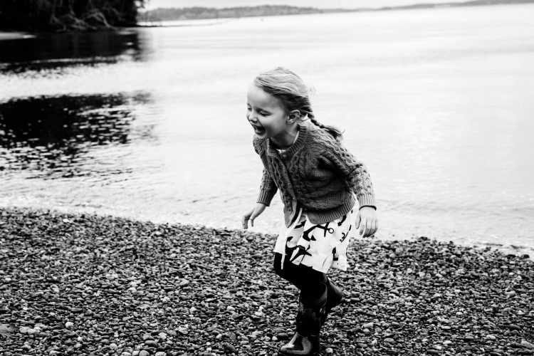 girl laughing on the beach in Olympia