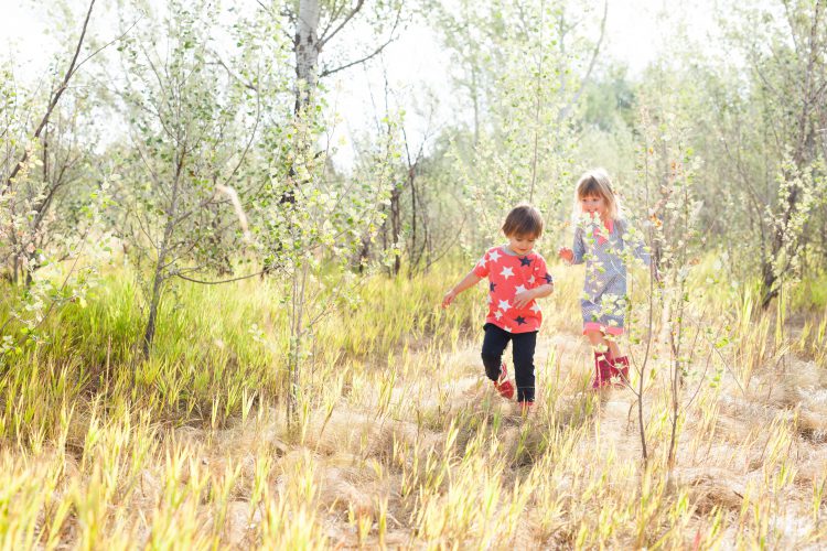 kids walking through a field