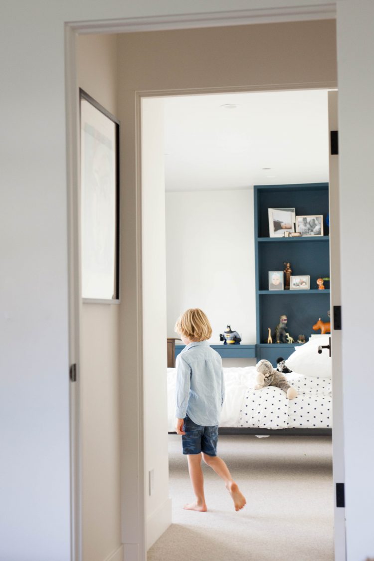 boy walking in modern home