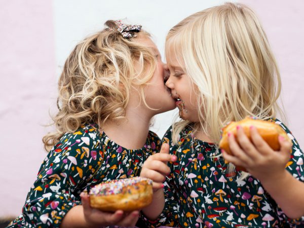 twins girls eating donuts