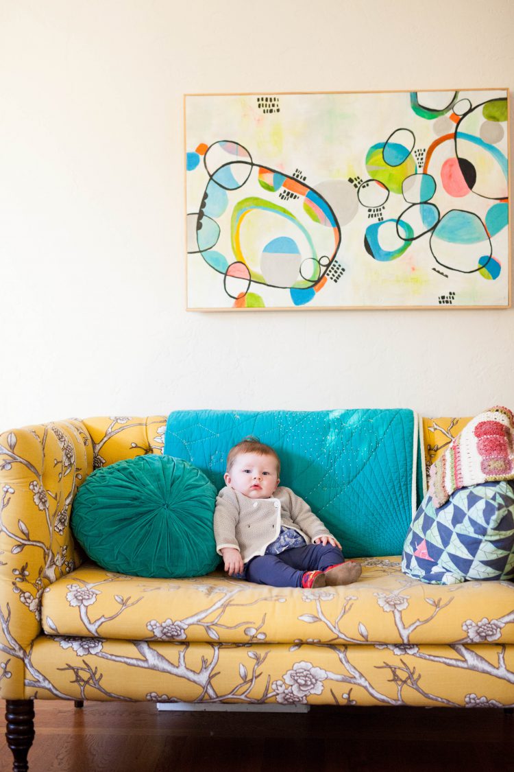 baby on a sofa  with modern wall art