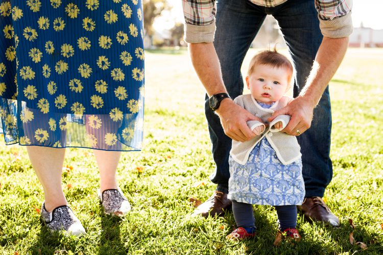 baby and parents in the grass