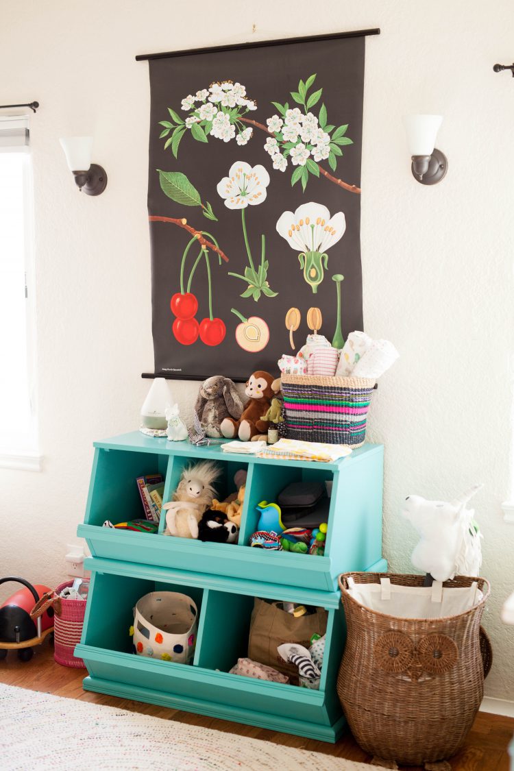 aqua green toy storage and floral wall art