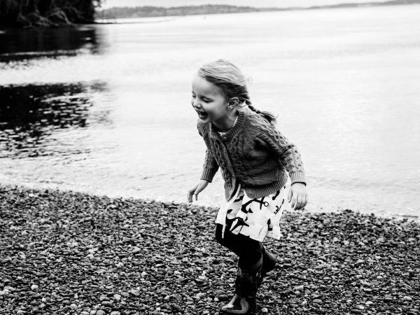 girl laughing on the beach in Olympia