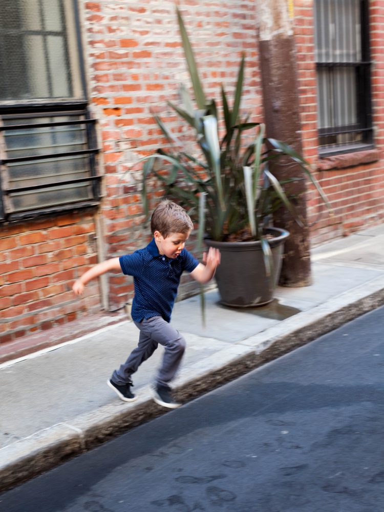 boy jumping off curb